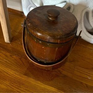 Antique wooden lunch pail with brass fittings.